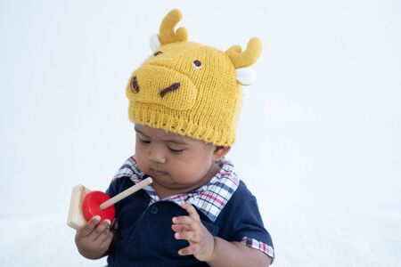 Cute little asian baby boy sitting and play toy