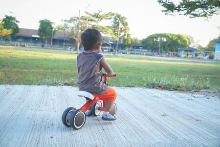 Boy playing a bicycle using a plowed leg is a bikeの写真素材