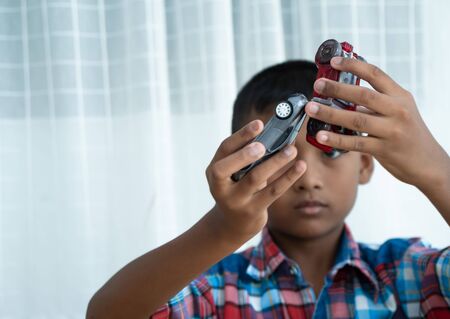 Cute little asian boy play toy car at roomの写真素材