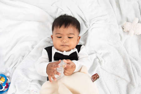 Little baby boy play and bite toyの写真素材