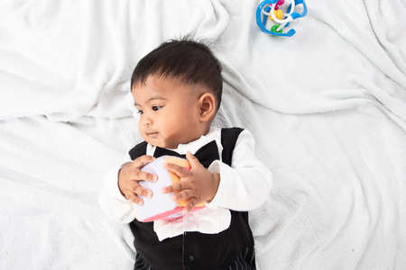Little baby boy play and bite toyの写真素材