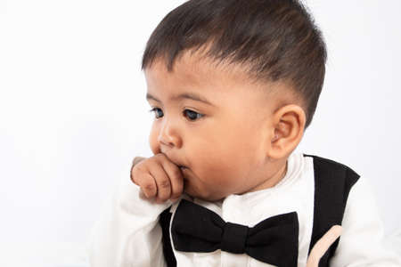cute little asian baby boy Suck a fingerの写真素材