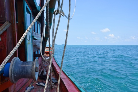 Fishing boats are going out to fish in the middle of the sea.の写真素材