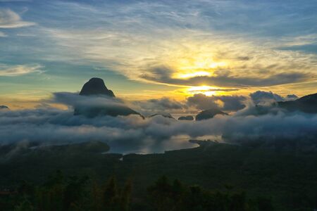 Morning with mist, surrounded by mountains and sea. Beautiful in Thailand.の写真素材