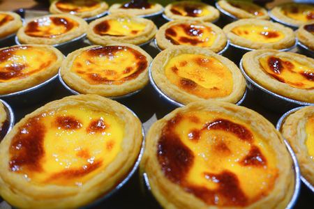 Many egg tarts cooked off the oven.の写真素材