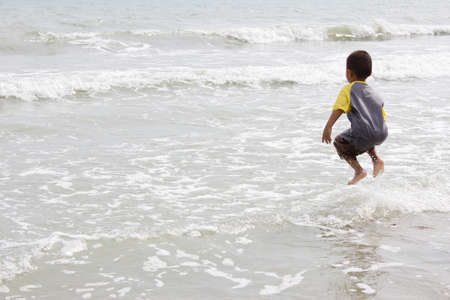 Rayong THAILAND : The child is jumping on the beach at Rayong Thailandのeditorial素材