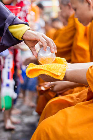 sprinkle water onto The monk in song klan festival Ladkrabang  Thailandのeditorial素材