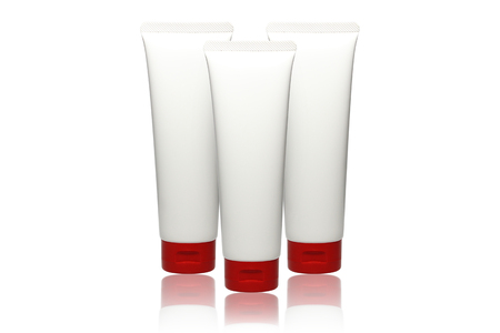 Three tube of cream, white plastic product, container, product and packaging on white backgroundの写真素材