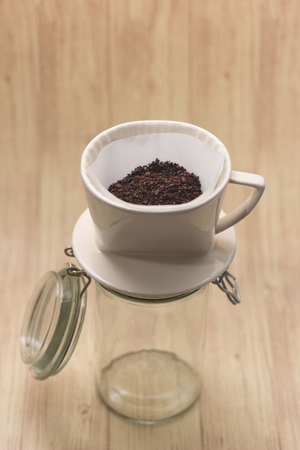 Drip coffee with paper filter tool on wood backgroundの写真素材