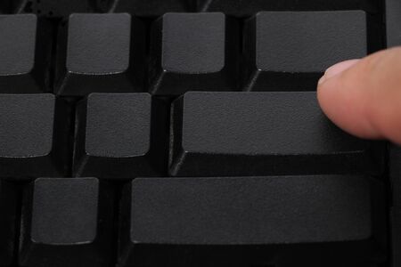computer keyboard and finger press on buttonの写真素材