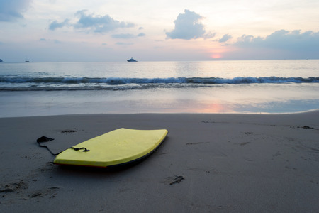 Surfboard on the beach at sunsetの写真素材