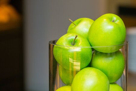Fresh green apples in bowl glassの写真素材