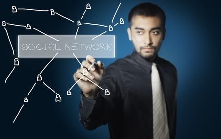 business man drawing social network on screenの写真素材