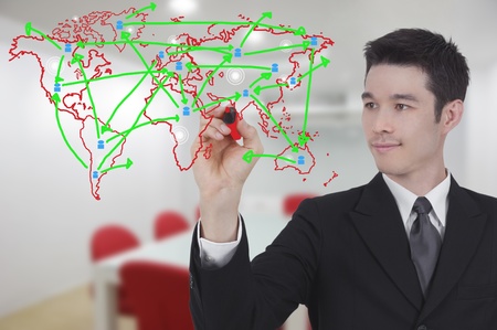 business man drawing world map graph in conference roomの写真素材