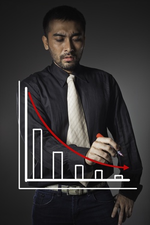 Business man point to falling graph of stock market の写真素材