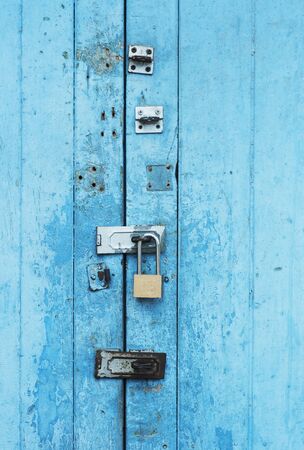 ancient blue door with iron door locked