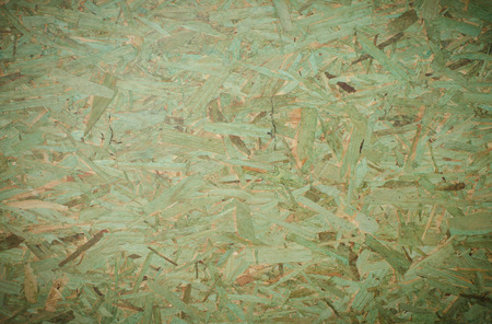 Green background OSB (Oriented Strand Board).