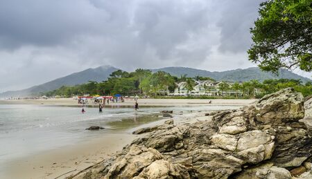BRAZIL, JUQUEI  -DECEMBER 20th, 2017 ;  Tourists on a rainy day on the beach in Juquei, Sao Paulo state, Brazil.のeditorial素材