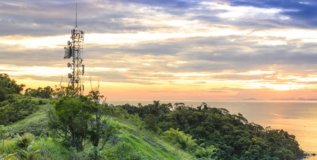 Telecommunications and  radio towers with sunset sky in background on the coast of Sao Paulo state.