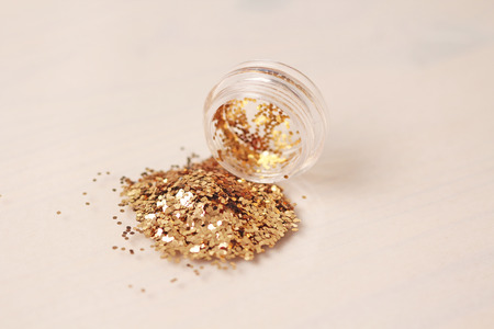Gold Sequins for the design of nails in a box. Glitter in jars. Foil for nail service. Photo set. Sparkling beauty shimmer, glitter.の写真素材