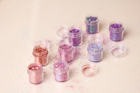 Multi-colored Sequins for the design of nails in a box. Glitter in jars. Foil for nail service. Photo set. Sparkling beauty shimmer, glitter.の写真素材