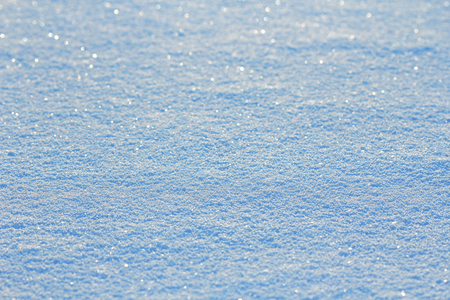 The blue and white snow glows and sparkles in the sun. Snowy backgroundの写真素材