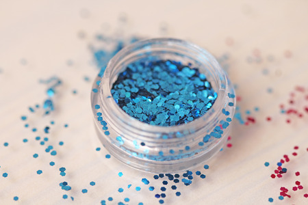 Blue Sequins for the design of nails in a box. Glitter in jars. Foil for nail service. Photo set. Sparkling beauty shimmer, glitter.の写真素材