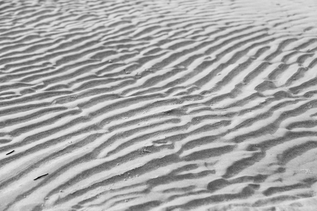 Gray background. Background of sand. Beautiful waves and sand dunes. A desert with beautiful waves. Design with copy space.の写真素材