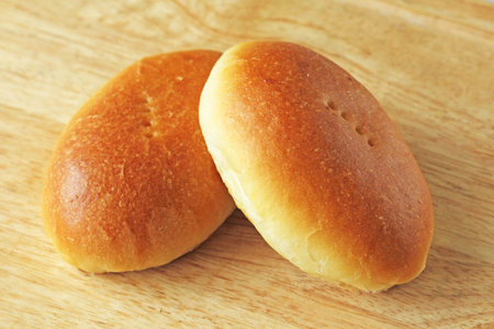 Russian traditional patties with egg and green onion lie on a wooden board. Delicious ruddy baked patties.の写真素材