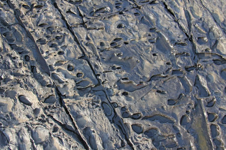 Abstract Background stone wall, texture. Grey or gray stone for background. Beautiful stone structure or texture. Design with copy space. Magmatic breed. Iron. Iron metallic background.の写真素材