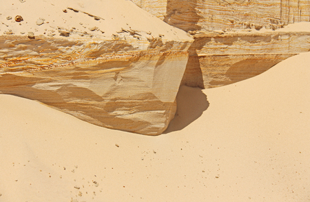 Sandstone cliff. Sandy slope with layered texture. Sand mountains in desert.の写真素材