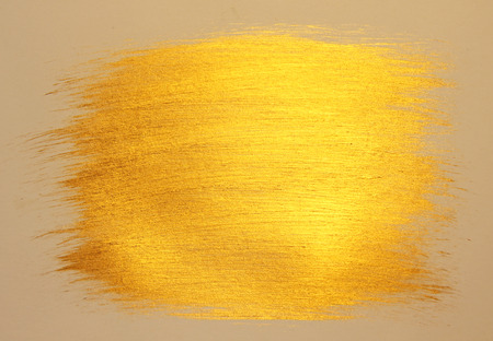 Golden shiny background. Bright golden background, sparkles and shines. A brush stroke.の写真素材