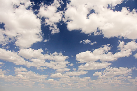 Beautiful white clouds, sun and blue sky as background.