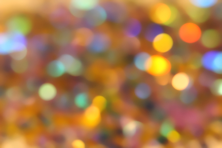 Blurred abstract creative background. Gold and yellow background. Lens flare. Colorful bokeh light. Illuminated burst of multicolor light.の写真素材