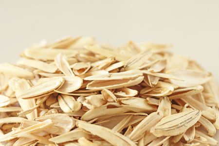 A pile of debris and peel from the seeds. Pile of waste from seeds on a white background. White sunflower seeds. Creative, cover, unusual. Garbage, rubbish.の写真素材