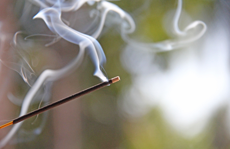 Incense stick and smoke from incense burning. Beautiful smoke. Blurred background and design with copy space.の写真素材
