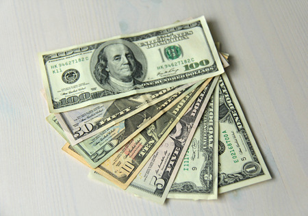 Paper dollars of different denominations - 1, 2, 5, 10, 20, 50 and 100 dollars. Background of dollars.の写真素材