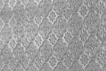 Gray and grey background glass. Old vintage glass with an abstract floral and geometric pattern. Design with copy space.の写真素材