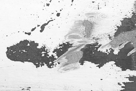 Old Flaky Paint Peeling off a Grungy Cracked Wall. Cracks, Peeling Old Paint and Plaster on Background of Old Cement Wall. White and Gray Spots of Paint. An Old Cement Stone Wall as Vintage Cracked.の写真素材