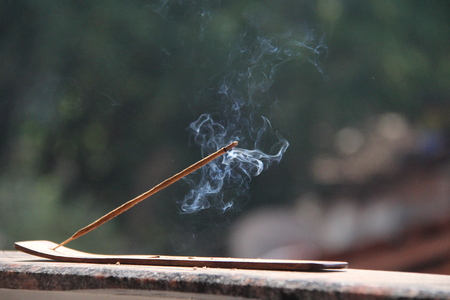 Incense stick and smoke from incense burning. Beautiful smoke. Blurred background and design with copy space.の写真素材