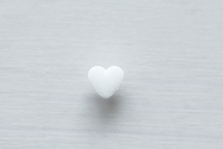 White heart on a white background. Design with copy space. Top view.
