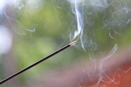 Incense stick and smoke from incense burning. Beautiful smoke. Blurred background and design with copy space.の写真素材