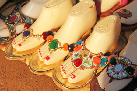 Ornaments on the foot. Shoes India is sold on the market in India. Gift souvenir India Tibet Bazaar.の写真素材