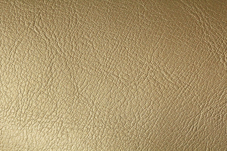 Gold Gradient Background. Gold or Bronze Natural Leather Background. Shiny yellow leaf gold foil texture background. Place for Text.の写真素材