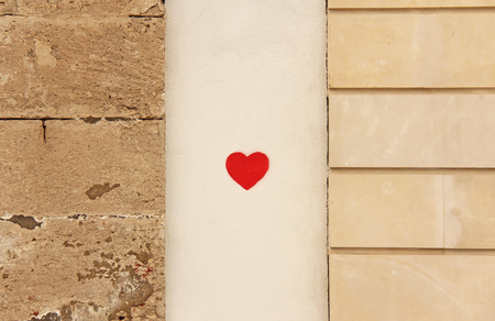 Red Heart Painted on the Wall of the House. Street art. The island of Sicily, Italy.の写真素材