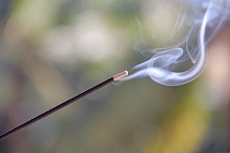 Incense stick and smoke from incense burning. Beautiful smoke. Blurred background and design with copy space.の写真素材