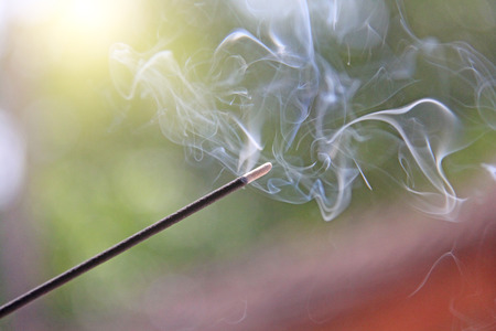 Incense stick and smoke from incense burning. Beautiful smoke. Blurred background and design with...