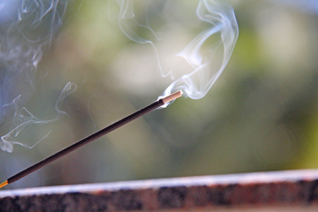 Incense stick and smoke from incense burning. Beautiful smoke. Blurred background and design with copy space.の写真素材