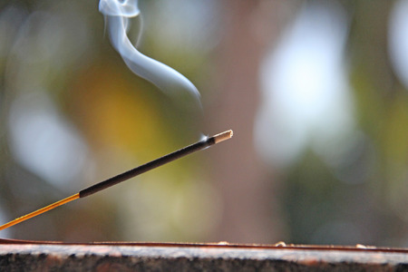 Incense stick and smoke from incense burning. Beautiful smoke. Blurred background and design with copy space.の写真素材
