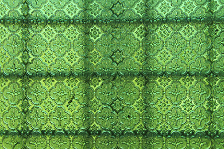 Green glass background. Old vintage glass with an abstract floral and geometric pattern. Design with copy space.の写真素材